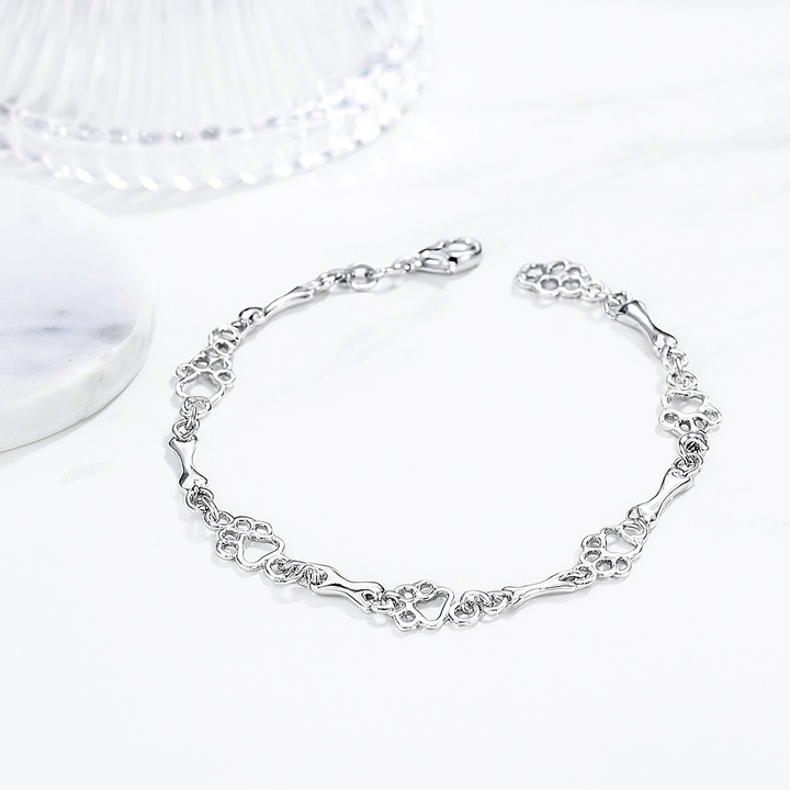 Armbånd med hundepote- og knoglecharm lavet af rent sølv